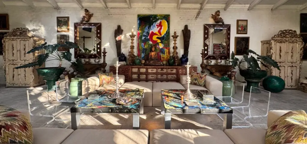 Showroom interior at Holler & Saunders featuring Spanish Colonial furniture, mirrors, and decorative art